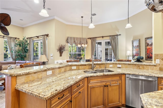 kitchen with a sink, light stone countertops, dishwasher, and hanging light fixtures