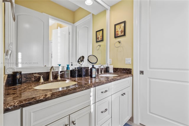 full bath with double vanity and a sink