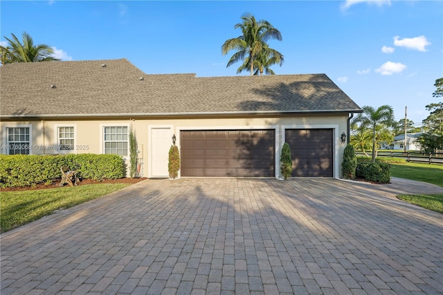 garage with decorative driveway