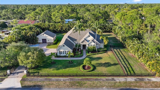 birds eye view of property featuring a view of trees