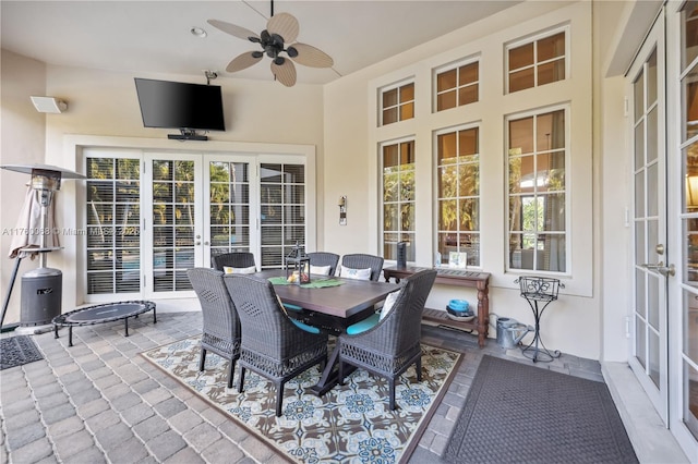 view of patio featuring a ceiling fan, outdoor dining space, and french doors