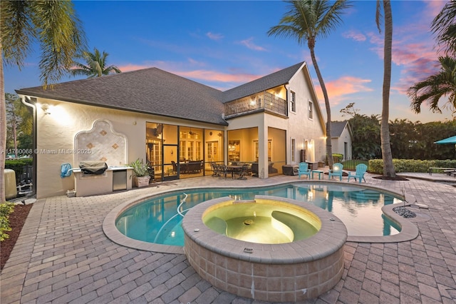 view of pool featuring a patio, area for grilling, and a pool with connected hot tub