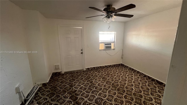 spare room featuring cooling unit, dark carpet, and ceiling fan