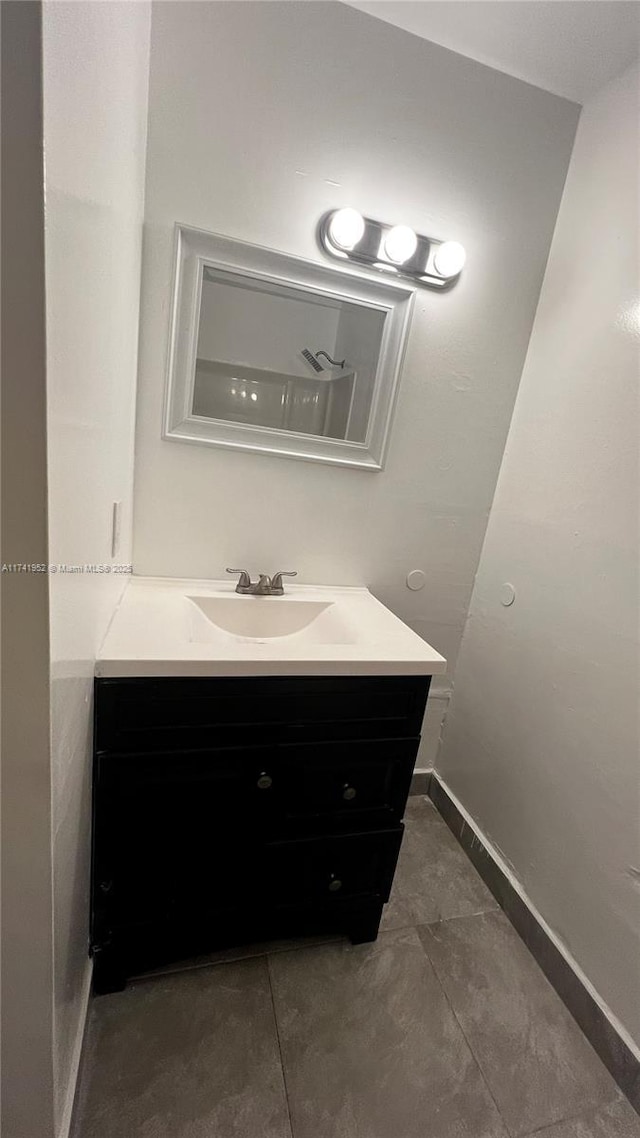 bathroom featuring baseboards and vanity