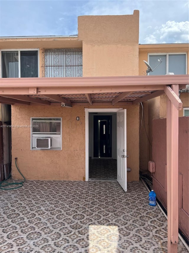 back of property with stucco siding