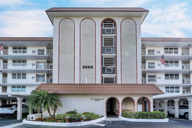 view of property featuring uncovered parking