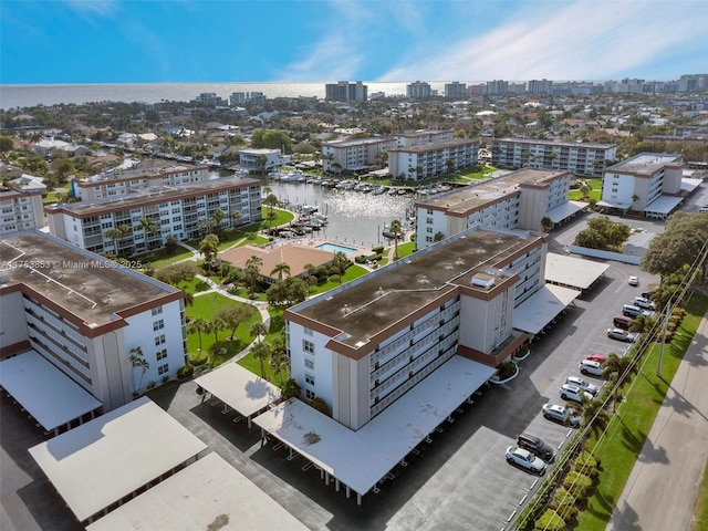 drone / aerial view with a city view and a water view