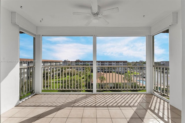 unfurnished sunroom with a ceiling fan