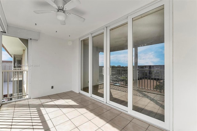 interior space featuring floor to ceiling windows, light tile patterned floors, and ceiling fan