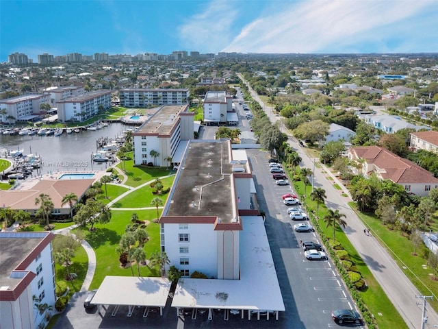 birds eye view of property featuring a water view and a city view