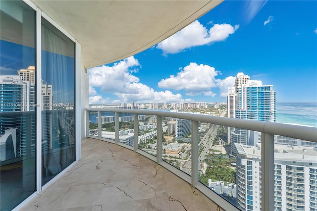 balcony featuring a view of city and a water view