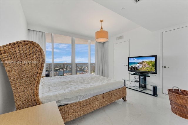 bedroom featuring visible vents, marble finish floor, and expansive windows