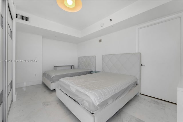 bedroom with visible vents, baseboards, and marble finish floor