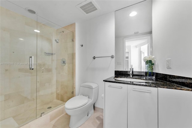 17201 Collins Ave Unit 3708, Sunny Isles Beach, FL 33160 - bathroom featuring toilet, vanity, a stall shower, and tile patterned floors