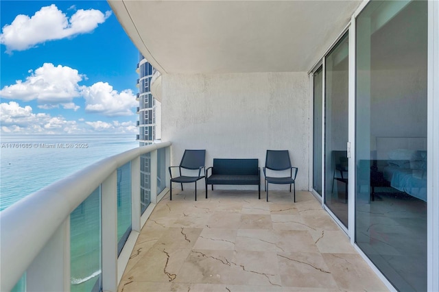 balcony featuring a water view