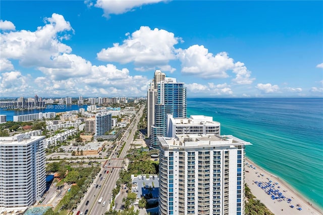 aerial view featuring a water view, a city view, and a beach view