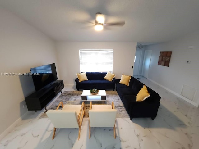 living area with marble finish floor, baseboards, and ceiling fan