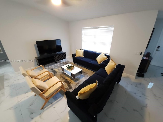 living room featuring baseboards and marble finish floor