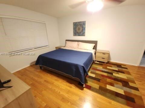 bedroom featuring ceiling fan and wood finished floors