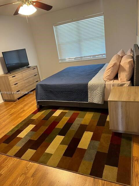 bedroom with ceiling fan and wood finished floors