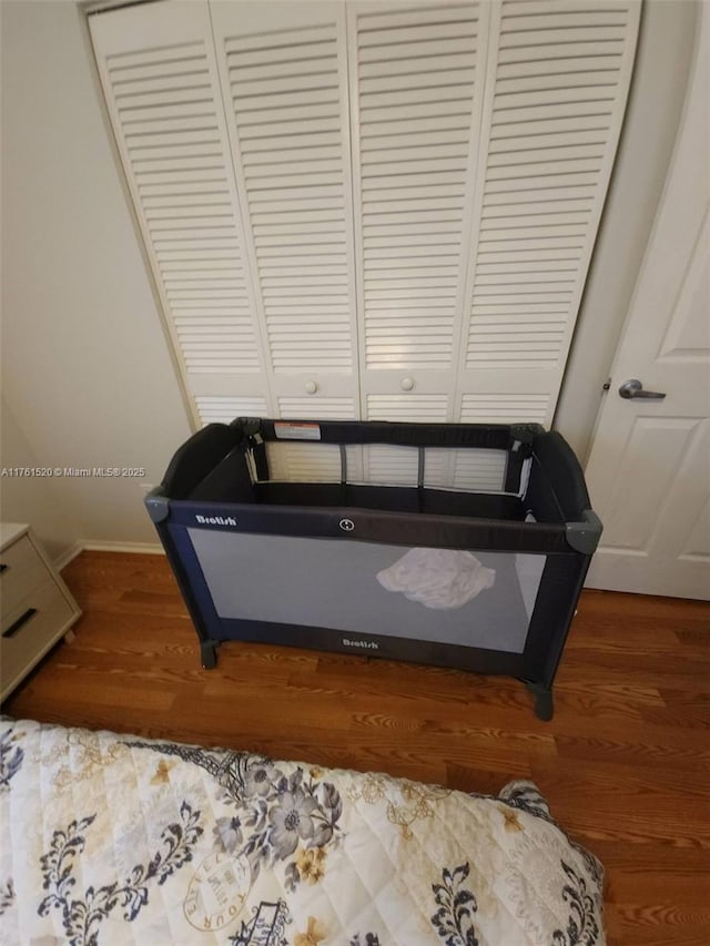 interior space featuring baseboards and wood finished floors