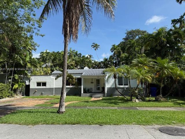 1643 Nethia Dr, Miami, FL 33133 - view of front of home with a front lawn and a chimney