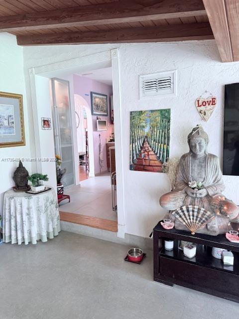 1643 Nethia Dr, Miami, FL 33133 - hallway featuring beamed ceiling, visible vents, wooden ceiling, and arched walkways