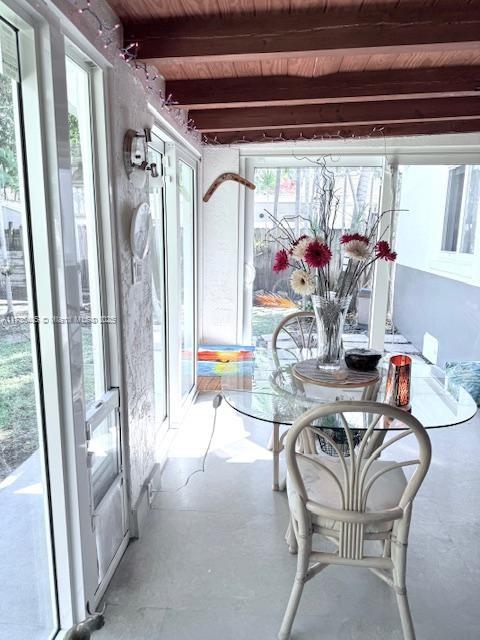 1643 Nethia Dr, Miami, FL 33133 - sunroom with concrete floors, wooden ceiling, and beamed ceiling