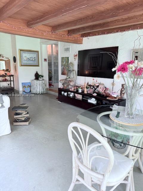 1643 Nethia Dr, Miami, FL 33133 - living area with wooden ceiling, beamed ceiling, finished concrete floors, and visible vents