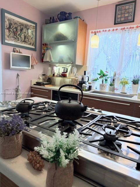 kitchen with light countertops and pendant lighting