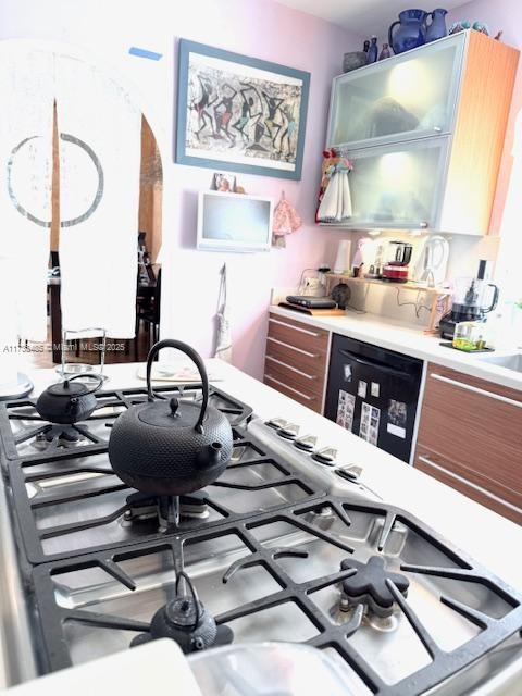 1643 Nethia Dr, Miami, FL 33133 - kitchen featuring light countertops and stainless steel gas cooktop