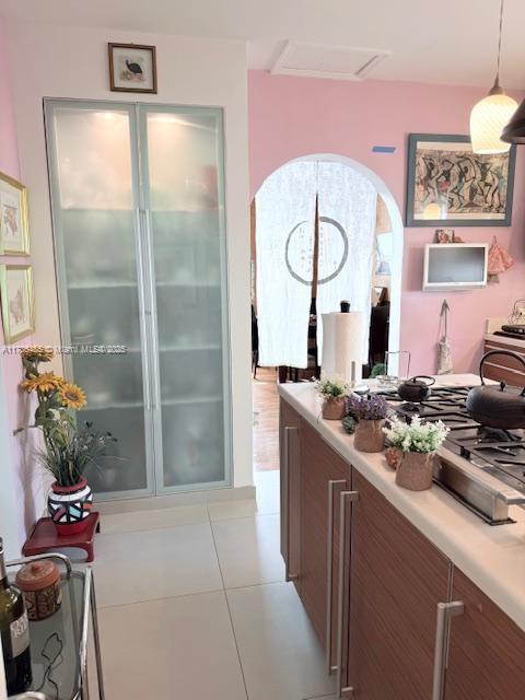 1643 Nethia Dr, Miami, FL 33133 - corridor featuring light tile patterned floors and attic access