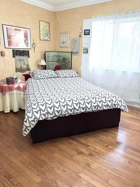 1643 Nethia Dr, Miami, FL 33133 - bedroom featuring crown molding and wood finished floors