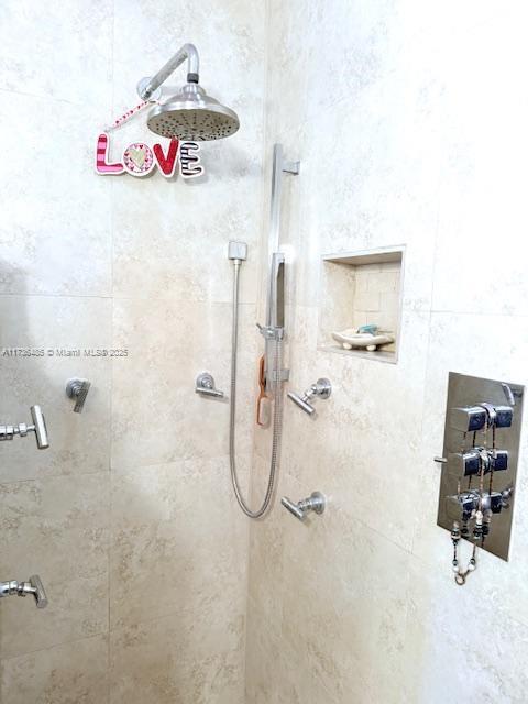 bathroom with a tile shower