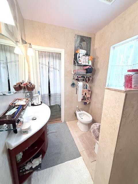 1643 Nethia Dr, Miami, FL 33133 - bathroom featuring tile patterned floors, vanity, and a bidet