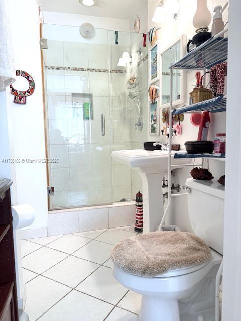 1643 Nethia Dr, Miami, FL 33133 - bathroom featuring a shower stall, toilet, and tile patterned flooring