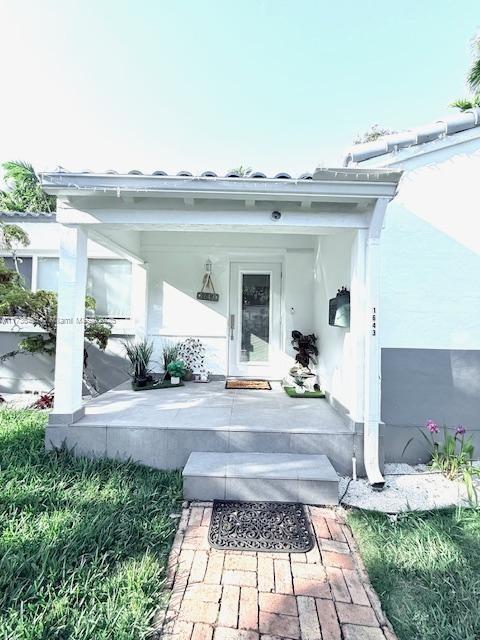 1643 Nethia Dr, Miami, FL 33133 - property entrance with a porch and stucco siding