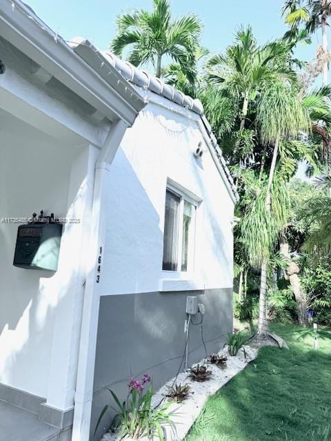 1643 Nethia Dr, Miami, FL 33133 - view of home's exterior with stucco siding and a lawn