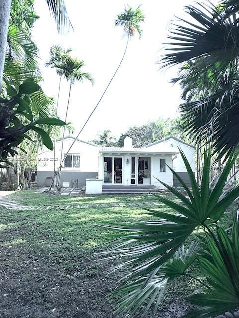 back of house with a lawn