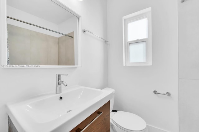 bathroom with toilet and vanity