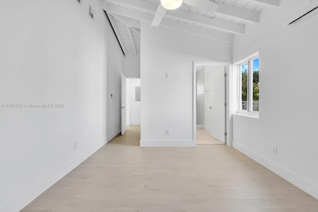 empty room featuring a wall mounted air conditioner, light wood-type flooring, beamed ceiling, and wooden ceiling