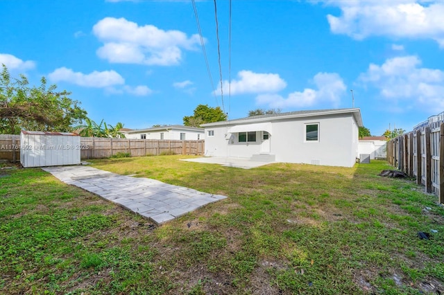 back of house with a storage unit, stucco siding, a patio, a fenced backyard, and an outdoor structure