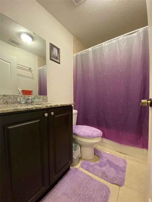 bathroom with vanity, visible vents, tile patterned flooring, a textured ceiling, and toilet