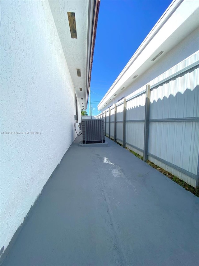 view of patio featuring cooling unit and fence