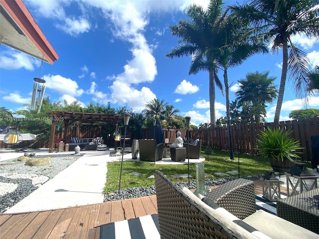 exterior space featuring a patio area, fence, a wooden deck, and a pergola