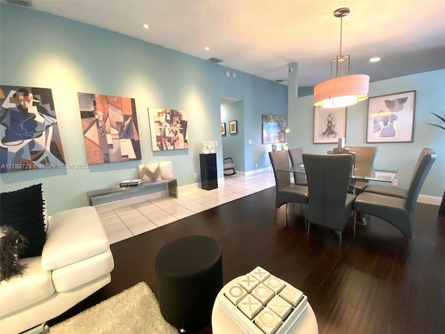 dining area featuring visible vents, baseboards, recessed lighting, wood finished floors, and a textured ceiling