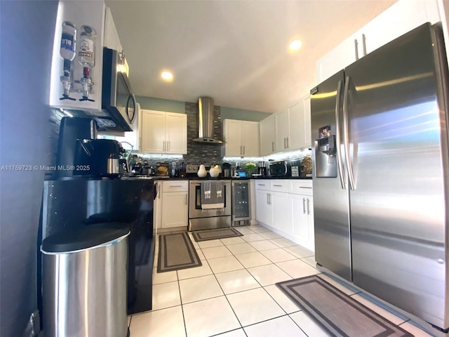 kitchen featuring tasteful backsplash, dark countertops, appliances with stainless steel finishes, wall chimney range hood, and light tile patterned floors