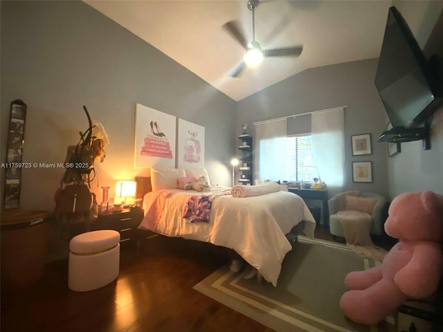 bedroom featuring a ceiling fan, lofted ceiling, and wood finished floors