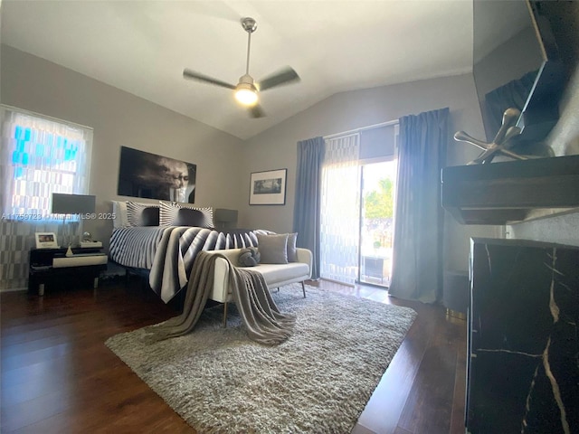 bedroom with lofted ceiling, ceiling fan, and dark wood-style flooring