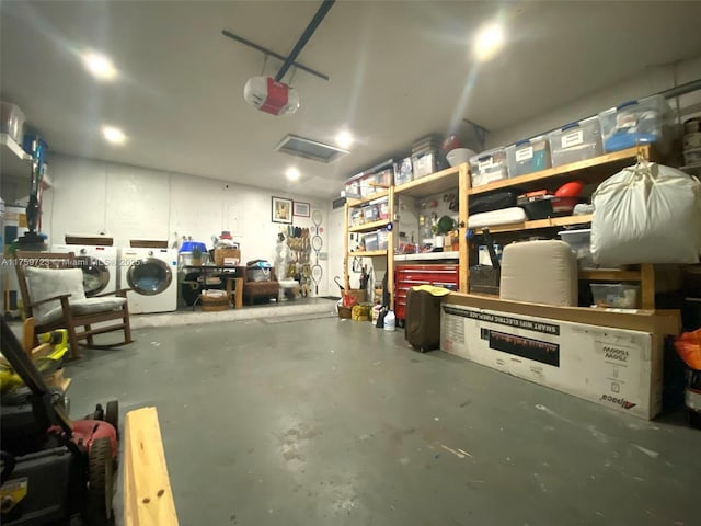 garage featuring washer and dryer, a workshop area, and a garage door opener